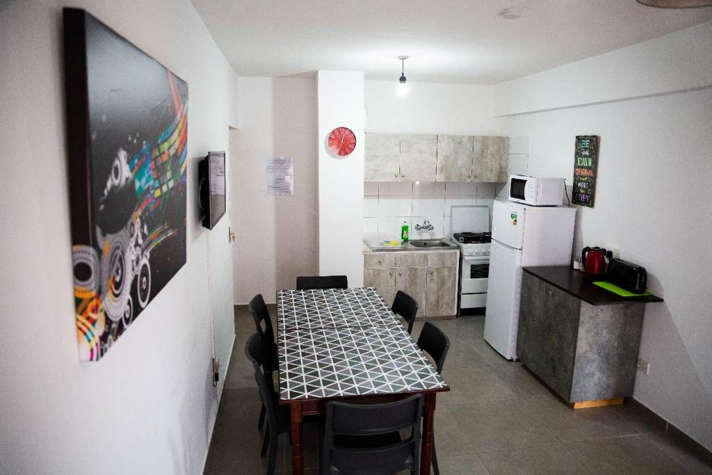 a kitchen with a table and a kitchen with a refrigerator at Olive Island in Larnaka