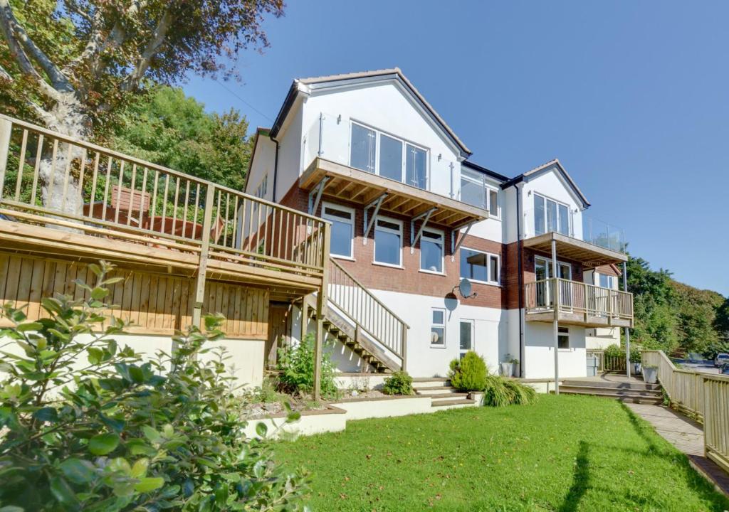 an exterior view of a house with a yard at Rock House in Ilfracombe