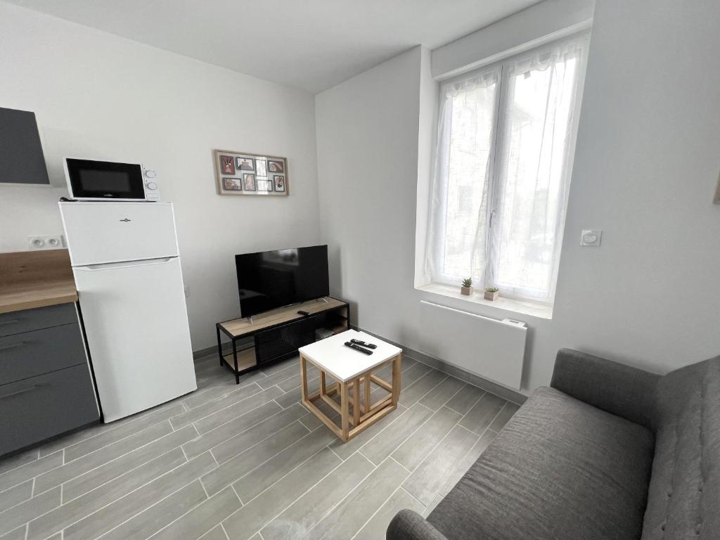 a living room with a couch and a television at 180A - Duplex T2 Tout Confort du Gond - 45 m2 in Le Gond-Pontouvre