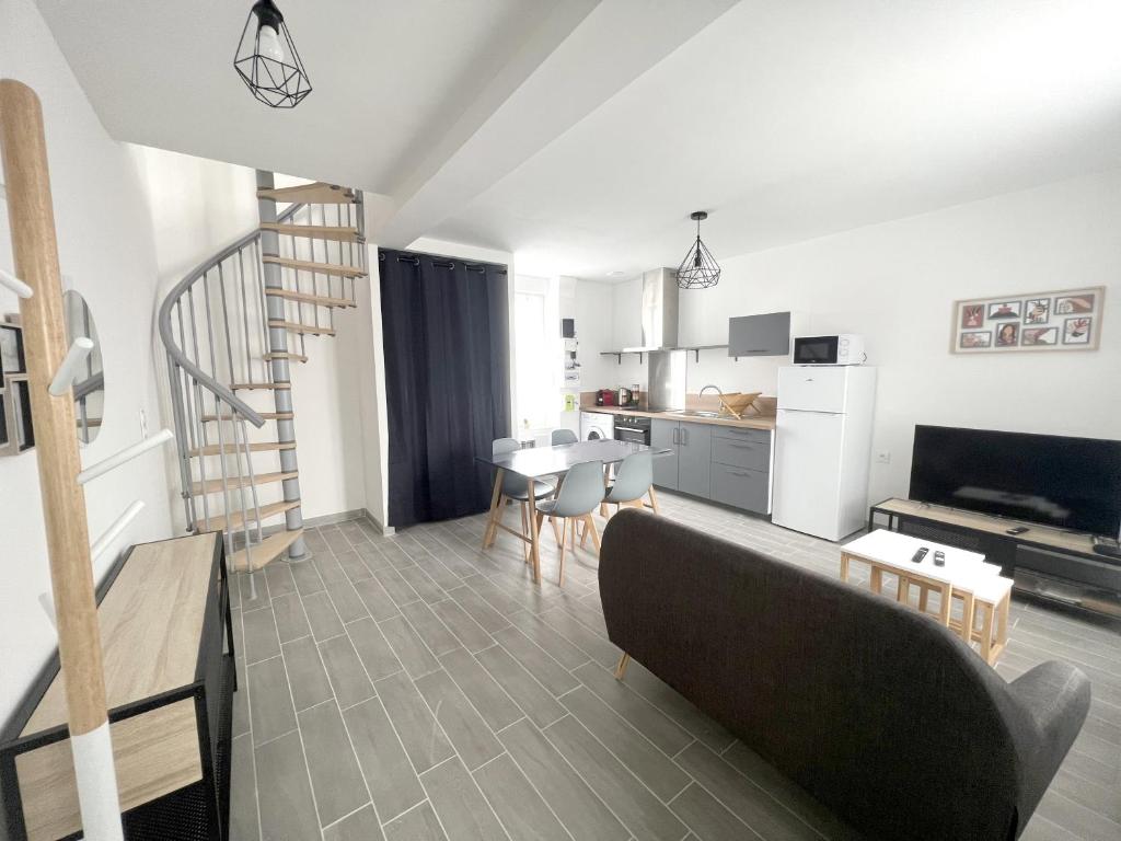 a living room with a couch and a table and a kitchen at 180A - Duplex T2 Tout Confort du Gond - 45 m2 in Le Gond-Pontouvre