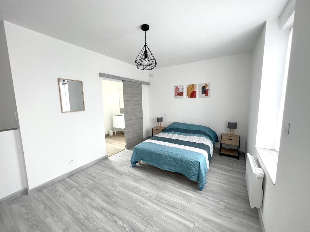 a white bedroom with a bed and a pendant light at 180A - Duplex T2 Tout Confort du Gond - 45 m2 in Le Gond-Pontouvre
