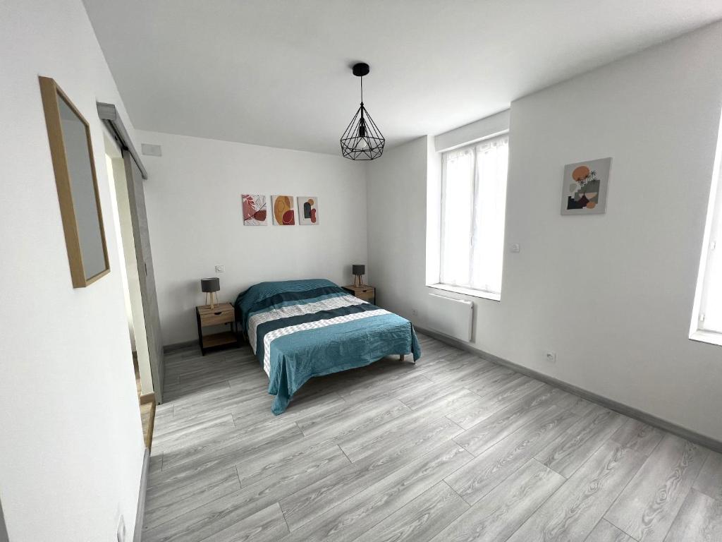 a white bedroom with a bed and two windows at 180A - Duplex T2 Tout Confort du Gond - 45 m2 in Le Gond-Pontouvre