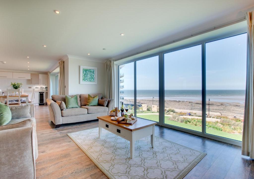 a living room with a view of the ocean at Sea Spray in Westward Ho