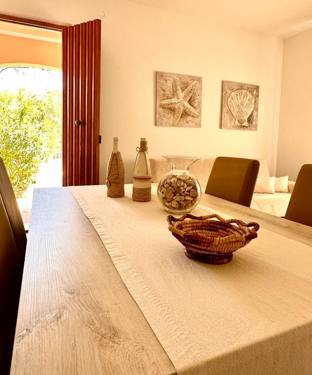 a table with a bowl on top of it at Sea Rocks House in Olbia