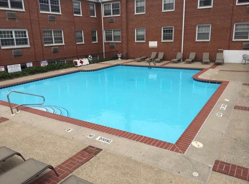 a large swimming pool in front of a building at 2BR Heritage Hill Apt Long Stay Discount in Grand Rapids
