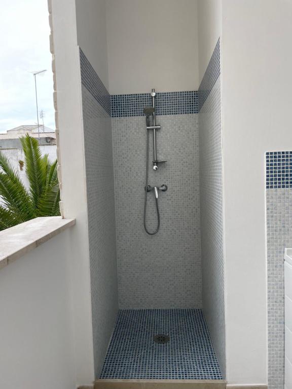 bagno con doccia e piastrelle blu di PIACENTINI - Apulia Home a San Pietro in Bevagna