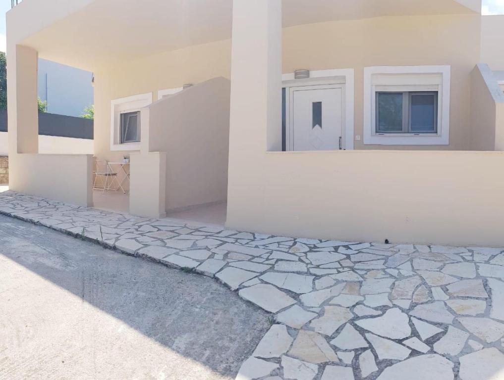 a rendering of a house with a stone walkway at Katy's Luxury Aparments in Kavros