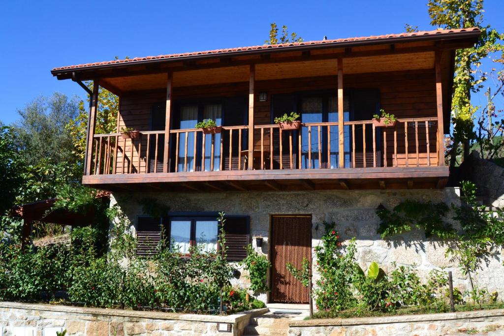 a house with a balcony on top of it at Charming House in Celorico de Basto with Mountain View in Celorico de Basto