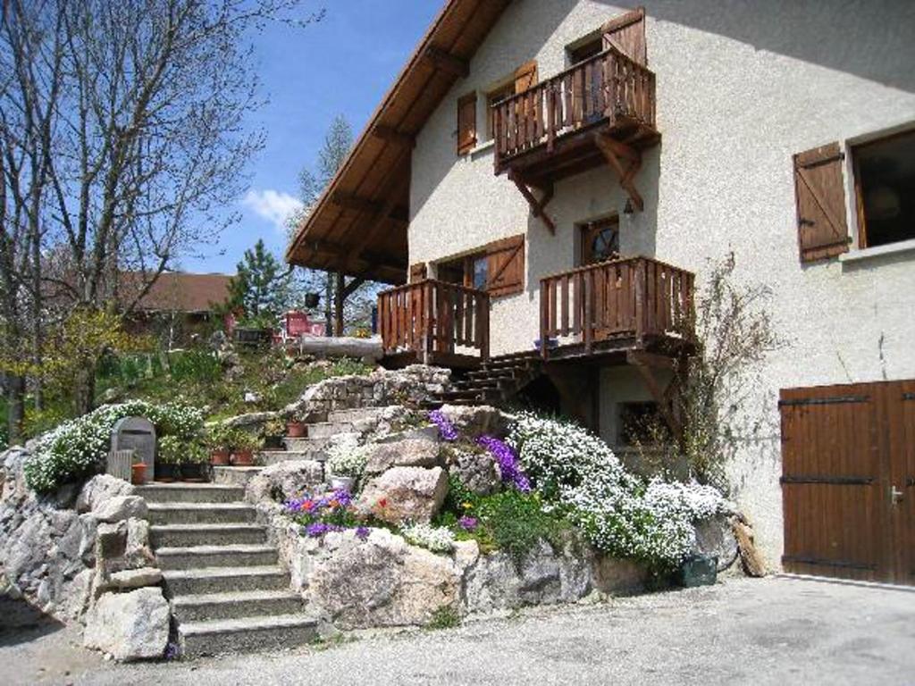 a house with stairs and wooden balconies on it at Appartement d'une chambre avec wifi a Gresse en Vercors a 2 km des pistes in Gresse-en-Vercors