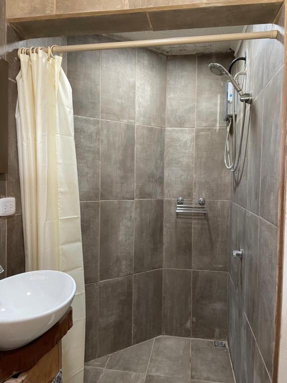 a bathroom with a shower and a sink at Casa Mano de Tigre in Potrerillos
