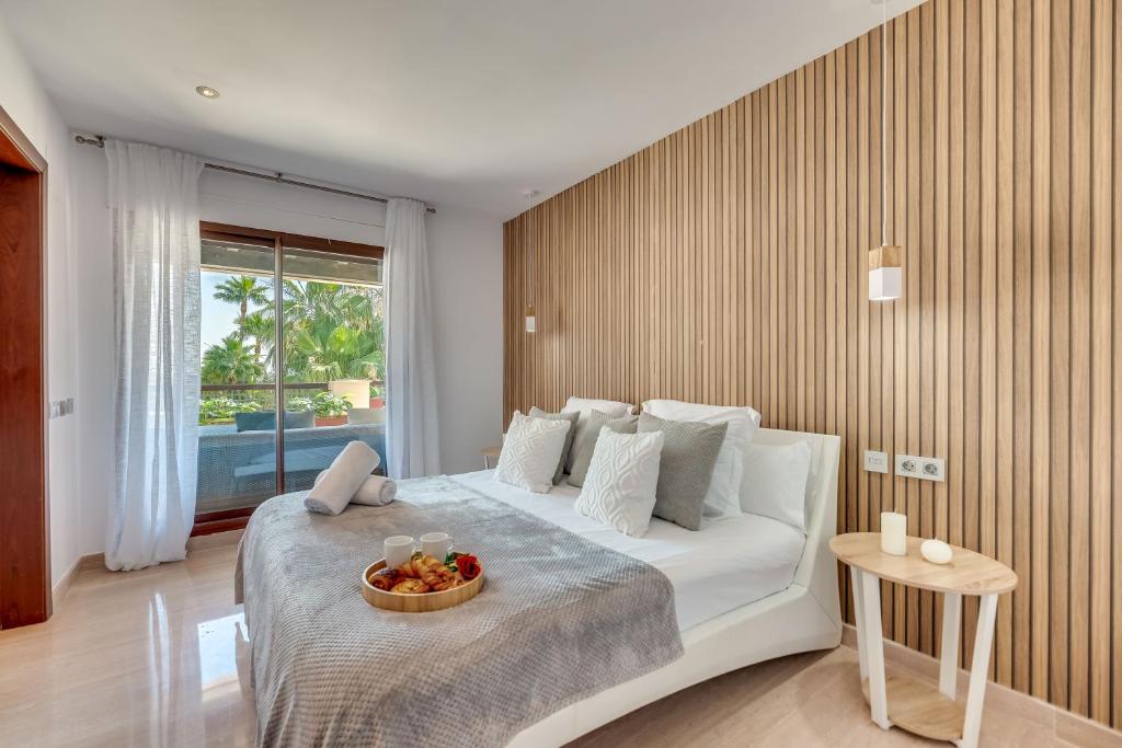 a bedroom with a bed with a bowl of fruit on it at VACATION MARBELLA I 300 SQM Penthouse, Private Swimming pool, BBQ, WiFi in Marbella