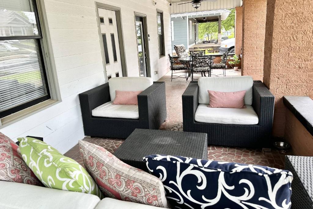 a screened porch with two chairs and a table at Adair Park Bungalow in Atlanta