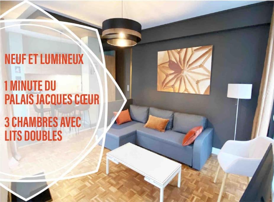a living room with a blue couch and a table at Les Quatre Piliers - 1 min Palais Jacques Cœur in Bourges