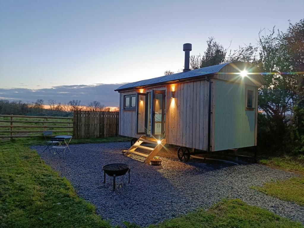 a tiny house sitting on gravel in a yard at Old Quay Escape in Tenby