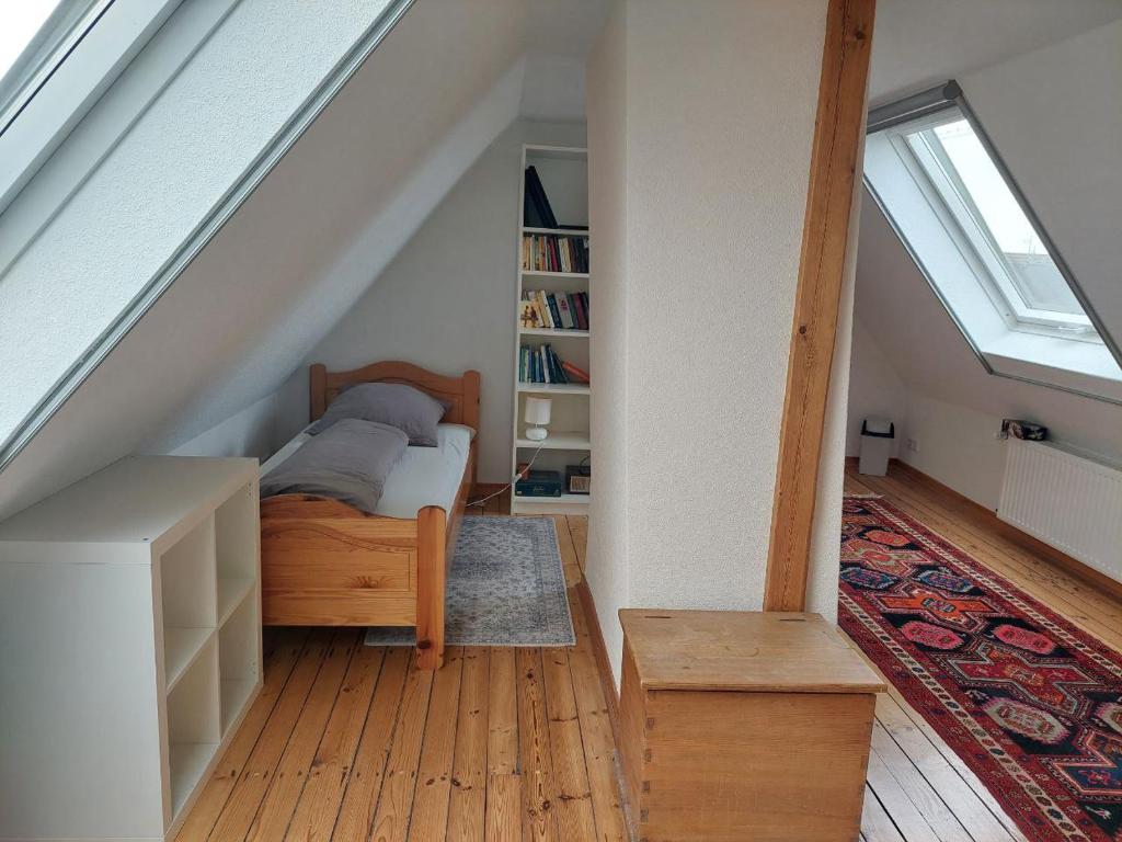 a bedroom with a bed and a book shelf at Ferienwohnung Lojane in Kranenburg