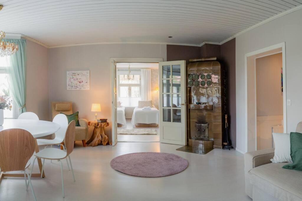a living room with a couch and a table at Villa Moisio - puutaloidylliä Salon keskustassa in Salo