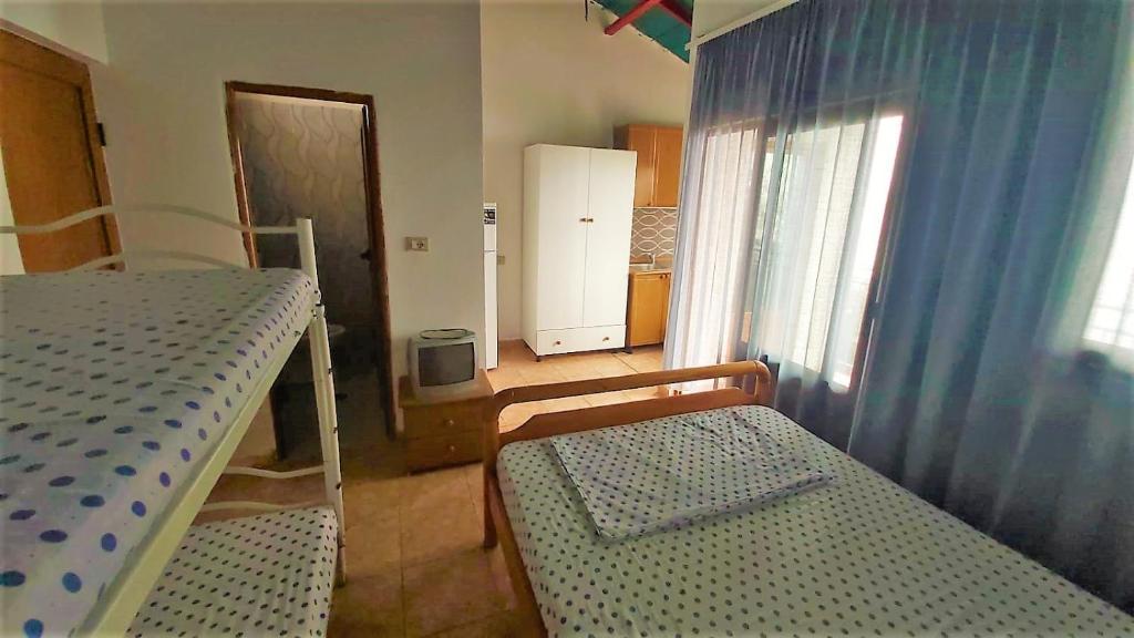 Third Room of Cozy Beachside Haven - Panoramic Radhime Retreat with Balcony Dining - Image 2