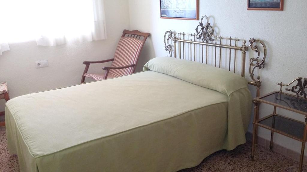 a bedroom with a bed and two chairs at 2 bedrooms apartement with sea view shared pool and furnished balcony at Aguilas in Águilas