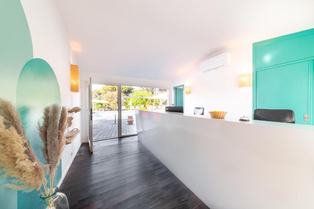 a kitchen with a white counter and blue cabinets at Les Capucines Saint Tropez in Saint-Tropez