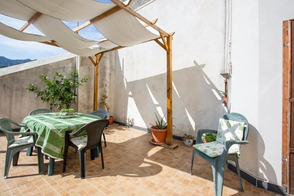 a patio with a table and chairs on a patio at 4 bedrooms apartement with furnished terrace and wifi at Cava de' Tirreni 3 km away from the beach in Cava deʼ Tirreni