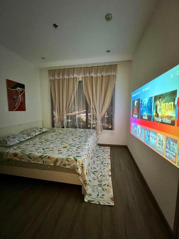 a bedroom with a bed and a large screen at Smart homestay in Hanoi