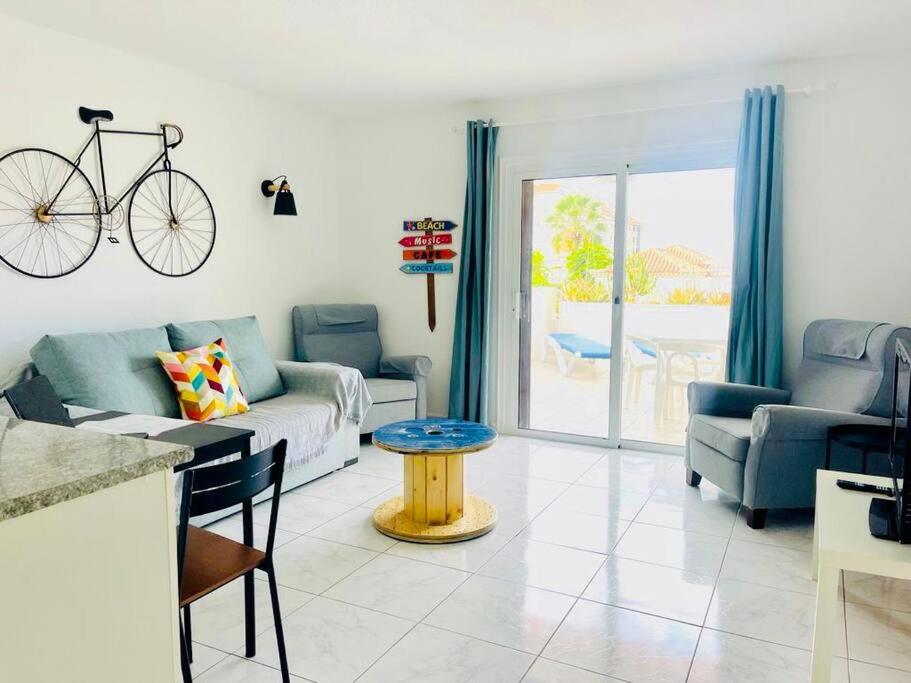 a living room with a bike hanging on the wall at Comfy home with large terrace five minutes from ocean in Los Cristianos