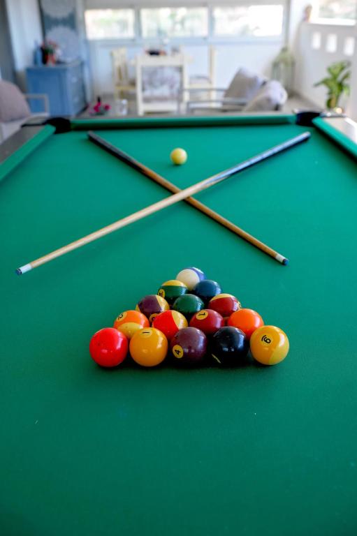 aroup of billiard balls on a green pool table at Harmony Villa in Kalymnos