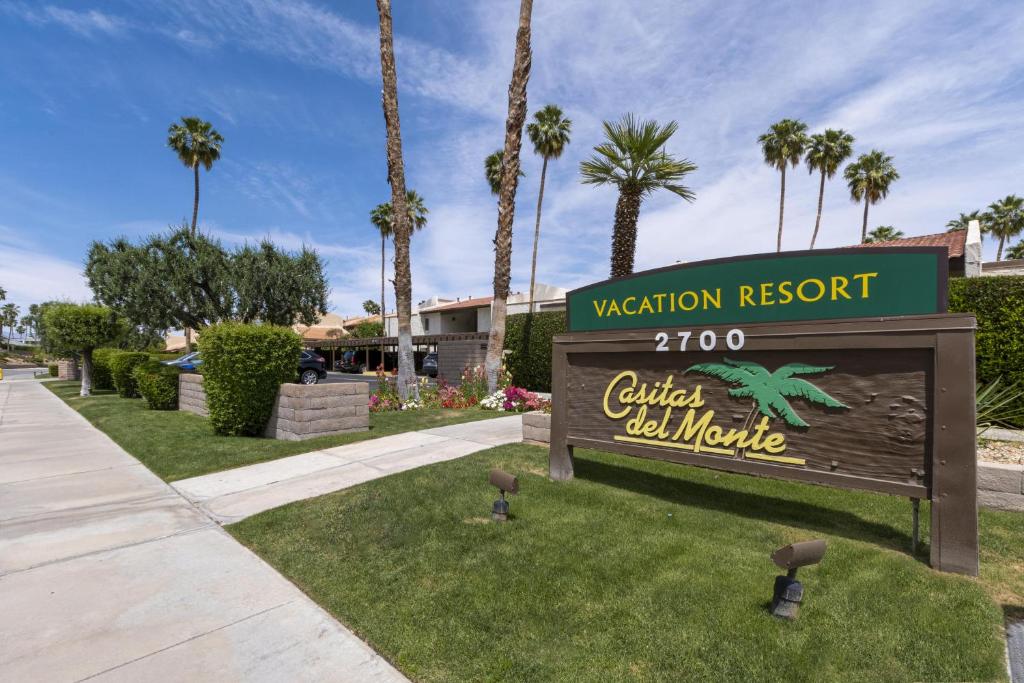 a sign for a vacation resort with palm trees at Casitas del Monte in Palm Springs