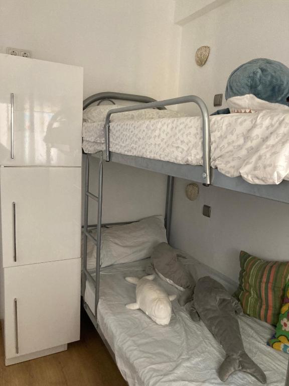 sypialnia z dwoma łóżkami piętrowymi w pokoju w obiekcie Apartamento 1ª linea de mar w mieście Almería