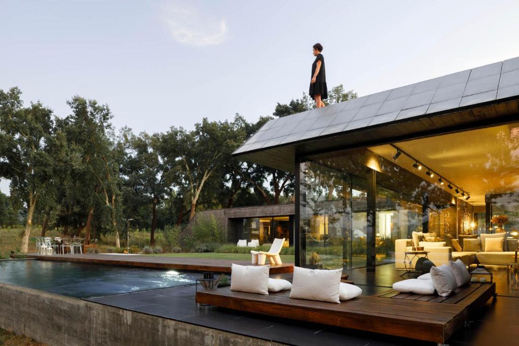 a man standing on top of a house at Casa dos Sobreiros by LovelyStay in Celorico de Basto