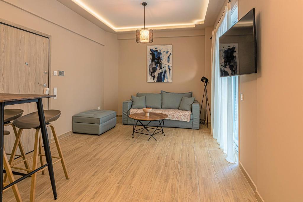 a living room with a couch and a table at Ventiri Suite 2 in Athens