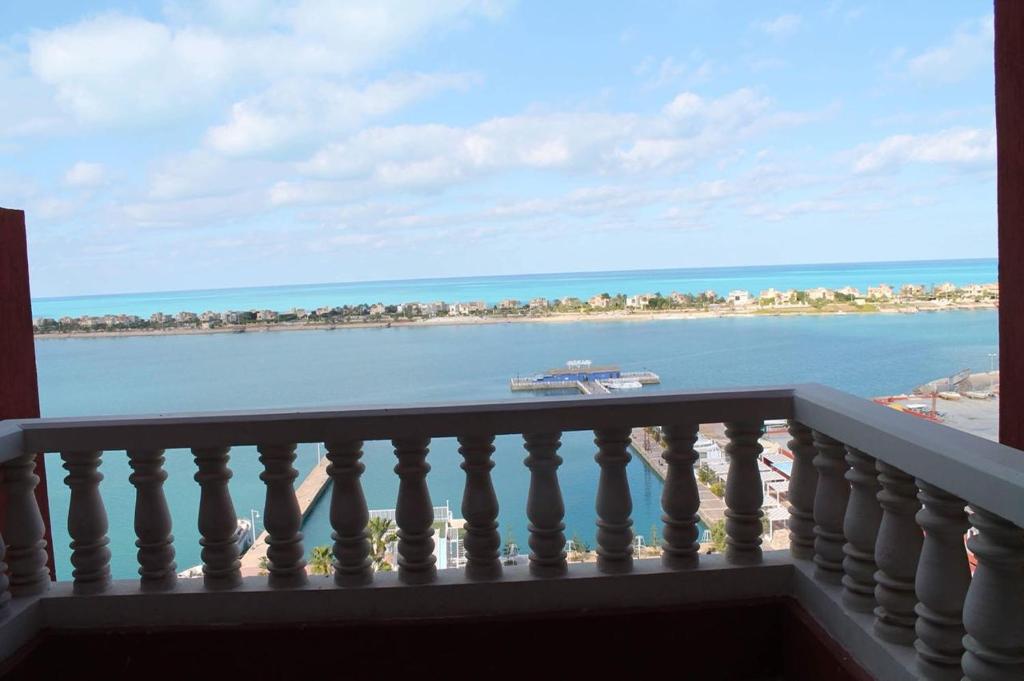 a balcony with a view of a boat in the water at بورتو مارينا in El Alamein