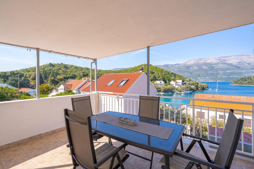 a blue table and chairs on a balcony with a view at Isola Bella in Korčula