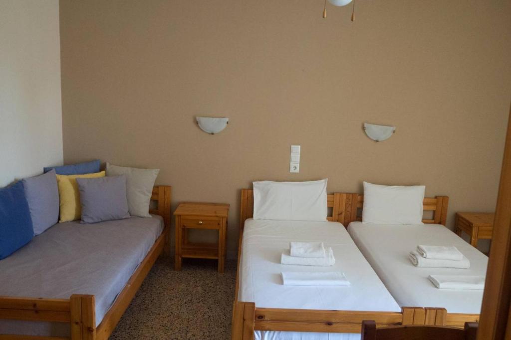 Łóżko lub łóżka w pokoju w obiekcie Kochili Apartments