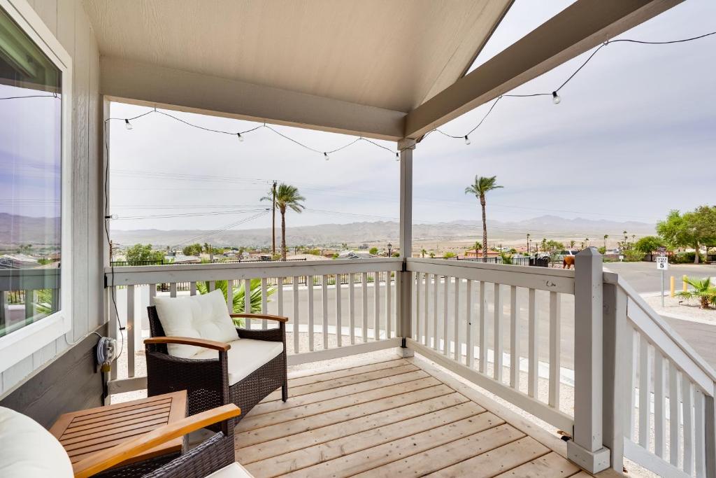 a porch with a couch and chairs on a balcony at Bullhead City Vacation Rental with Resort Pool! in Bullhead City