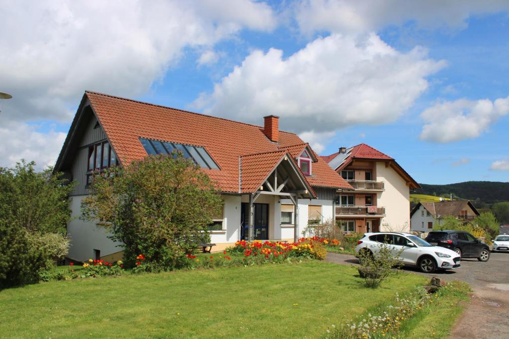 a house with a car parked in a parking lot at Josefine in Waldkappel