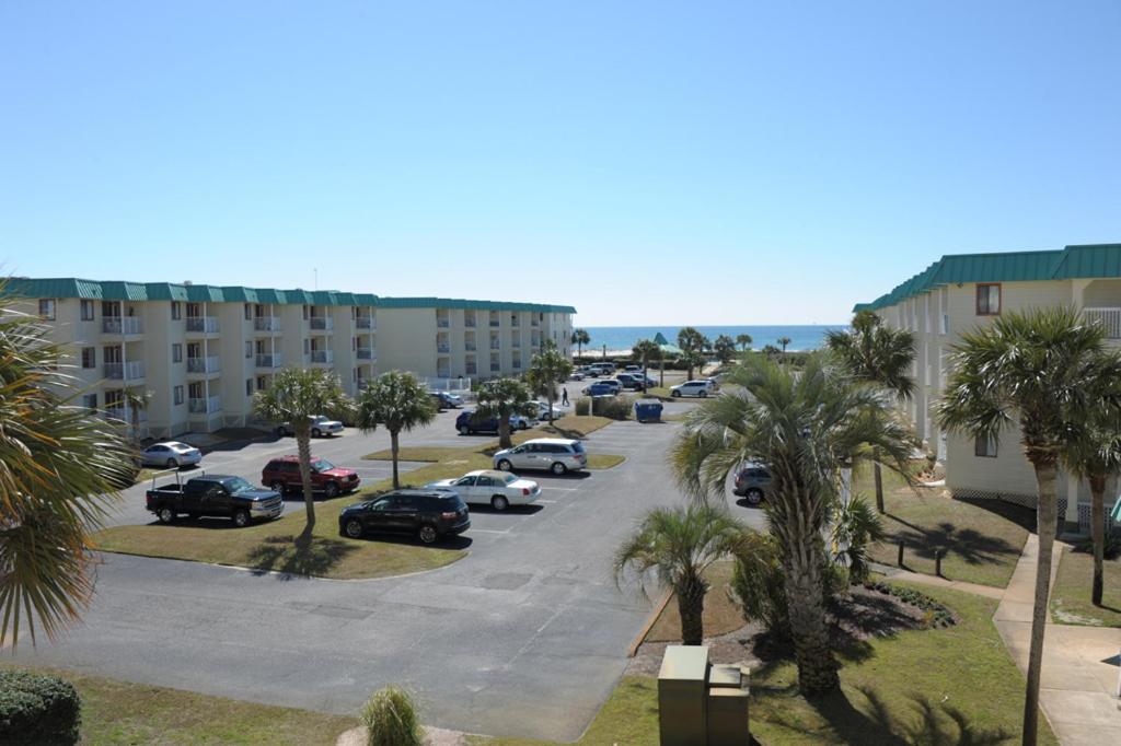 a parking lot with cars parked in front of a building at Gulf Shores Plantation 4307 by ALBVR - New Upgraded Condo and Building - Great Amenities in Gulf Highlands