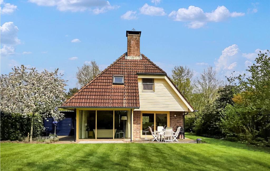 a house with a chimney on top of a yard at Cozy Home In Havelte With Wifi in Havelte