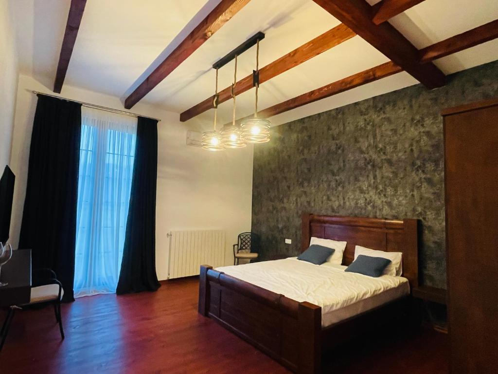 a bedroom with a large bed in a room at Javakhishvilebis Marani in Akhalsopʼeli