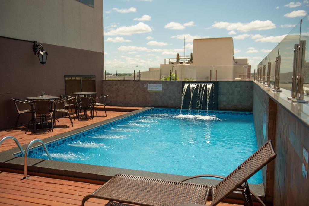 a swimming pool on the roof of a building at Bristol Infinity Rio Claro in Rio Claro