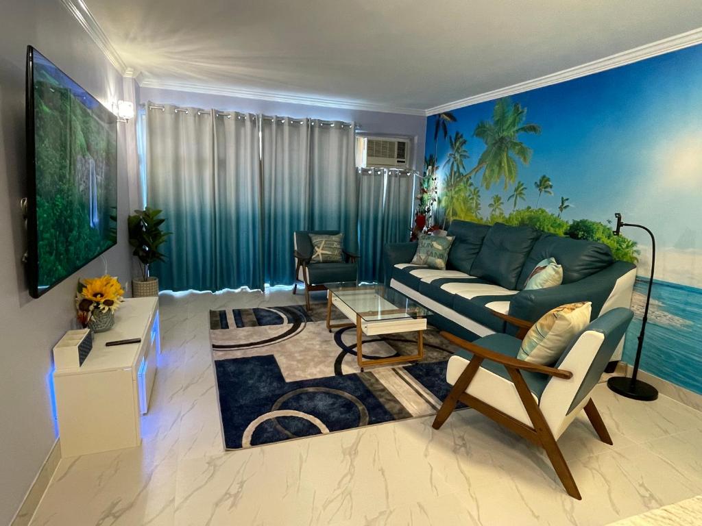 a living room with a couch and a tv at Amazing waikiki Beach condo 2Bed2Bath+free Parking in Honolulu