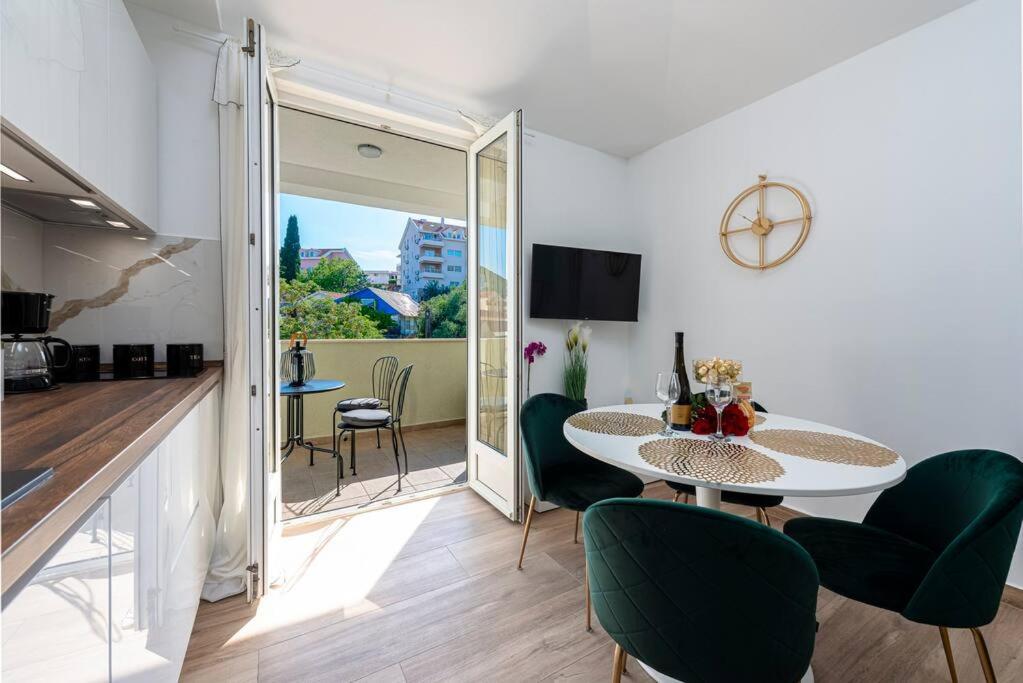ein Wohnzimmer mit einem Tisch und grünen Stühlen in der Unterkunft Apartment Kate with FREE PARKING in Dubrovnik