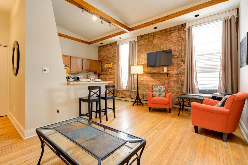 a living room with a glass table and chairs at St George Suites by Hoco Hotels Collection in Stratford