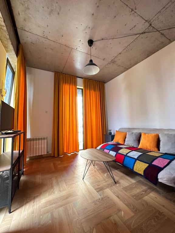 Schlafzimmer mit einem Bett und einem Tisch in der Unterkunft Gvazi Apartment in Tbilisi City