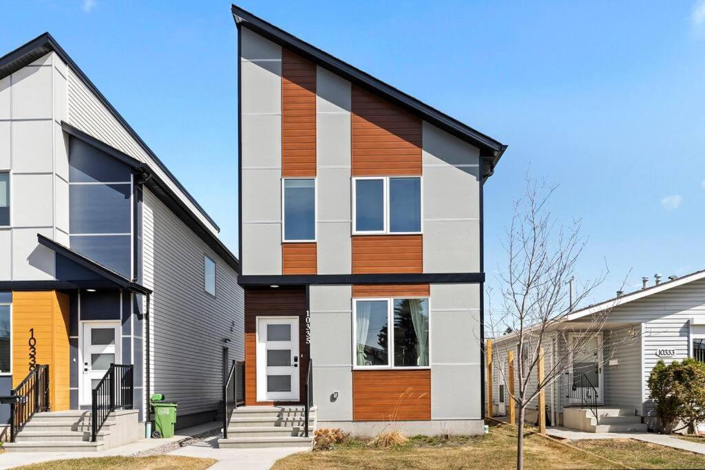 a house with wood accents on the side of it at Modern Luxury Home - King Bed•Arcade•WEM•A/C in Edmonton