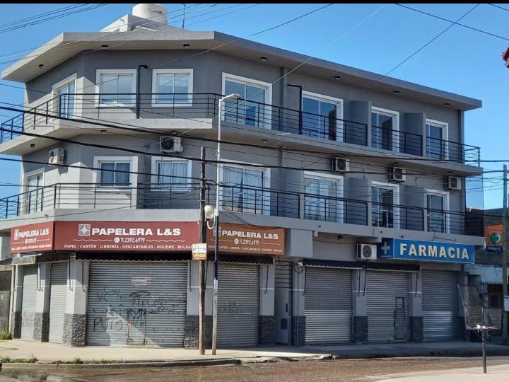 a large apartment building with a balcony on top of it at La Bonita in Ezeiza