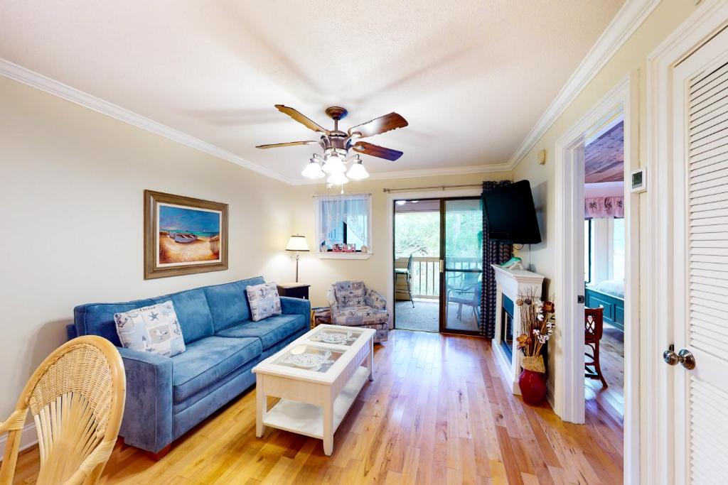 a living room with a blue couch and a table at Spa on Port Royal Sound 1321 in Hilton Head Island