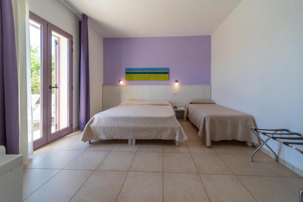 Postel nebo postele na pokoji v ubytování Corte dei Melograni Hotel Resort