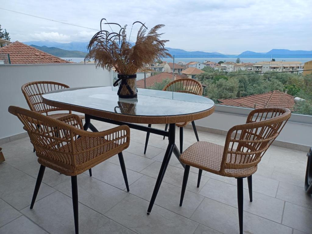 a table and chairs on a balcony with a view at Amelia Luxury Suite in Nikiana