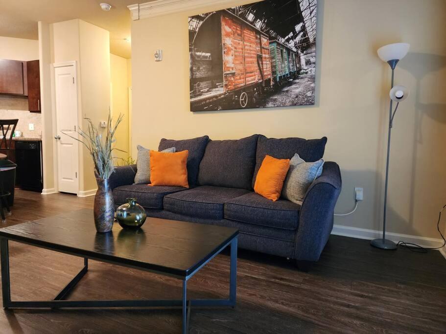 a living room with a couch and a coffee table at Adorable apartment w/ pool view in Charlotte